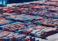 A bustling port with colorful cargo containers, aerial view showcasing global trade.