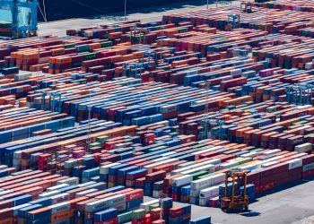 A bustling port with colorful cargo containers, aerial view showcasing global trade.