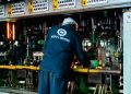 Worker supervises glass production at Kioo Limited factory in Dar es Salaam, Tanzania.