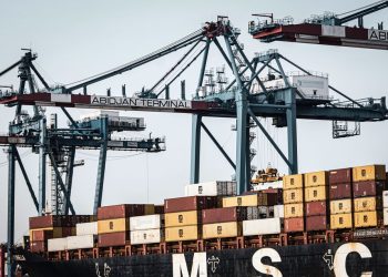 A view of large cranes and cargo containers at the busy Abidjan Terminal port.