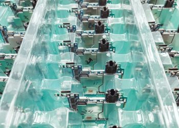 Detailed view of organized electronic circuit boards in a production setting.