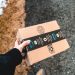 A person holding a cardboard Amazon Prime package on a snowy urban sidewalk.