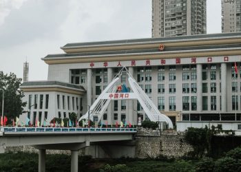 Urban scene featuring a bridge and government building in China.