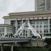 Urban scene featuring a bridge and government building in China.
