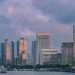 View of Shanghai's modern skyline at twilight with tall skyscrapers and vibrant clouds.