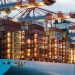 A vibrant cargo ship loaded with containers at Hamburg harbor, showcasing maritime industry.