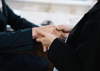 Close-up of two individuals in suits shaking hands, symbolizing business cooperation.