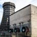 Abandoned industrial site in Essen, featuring a cooling tower and large fans.