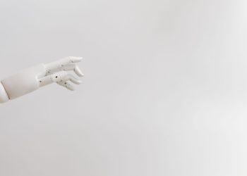 Minimalist image of a robotic hand reaching out on a white background.