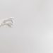Minimalist image of a robotic hand reaching out on a white background.