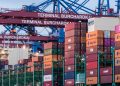 View of shipping containers and cranes at Hamburg's Burchardkai terminal.
