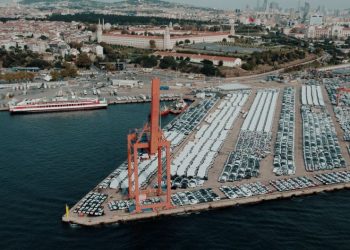 Aerial view of a bustling car shipping terminal in Istanbul, Türkiye, showcasing a busy port with vehicles ready for export.