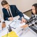 Business professionals engaging in a collaborative meeting with charts and documents.