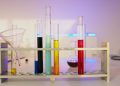 Vibrant test tubes filled with liquids in a modern lab setting, showcasing scientific exploration.