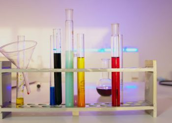 Vibrant test tubes filled with liquids in a modern lab setting, showcasing scientific exploration.