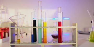 Vibrant test tubes filled with liquids in a modern lab setting, showcasing scientific exploration.
