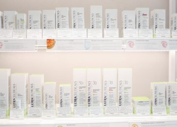 Neatly arranged Ultraceuticals skincare products on bright store shelves.