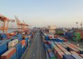 A bustling port scene with colorful cargo containers at sunrise. Ideal for logistics concepts.